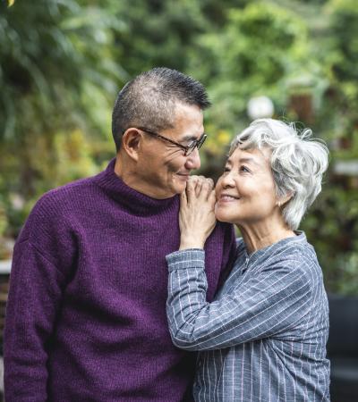 outdoor portrait of devoted senior Asian couple