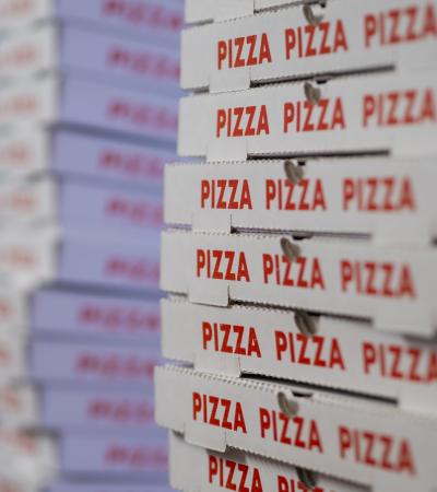 slant-angle view of stacks of pizza boxes