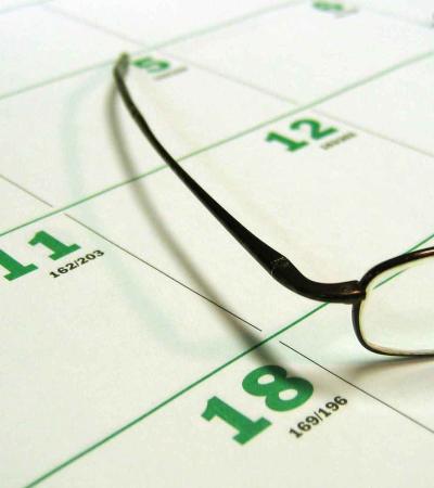 Calendar with glasses atop it