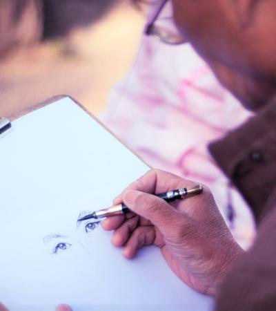 Photograph of person drawing a pair of eyes.