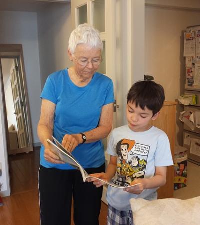 A boy and his grandmother reading