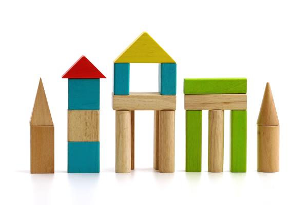 Photograph of wooden building blocks shaped as buildings.