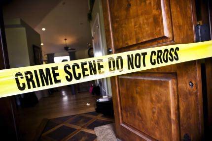 crime scene tape in entryway of residential home