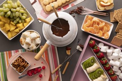 chocolate fondue dessert bar with cookies marshmallows and a variety of fruit