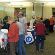 Patrons speaking with vendor at Senior Expo