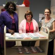 Cobb County librarians, from left, Jo Lahmon, Roxanne Magaw, and Stacy Hill with a group of free eyeglasses provided by the national non-profit Vision To Learn ready for schoolchildren.