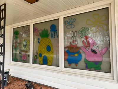 A photo of windows with Spongebob Squarepants characters painted on.