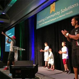 People on stage at a Creating Community Solutions event