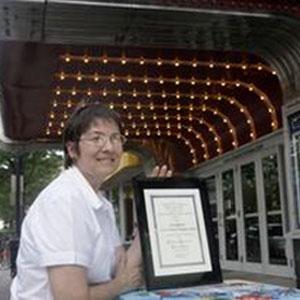 Nicolette Vaillancourt with the Jaffarian Award plaque, under the lights of the York Theater in Elmhurst, Ill.  Sarah Minor