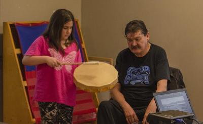 WFN elder Derry Fontaine teaches a young girl to drum
