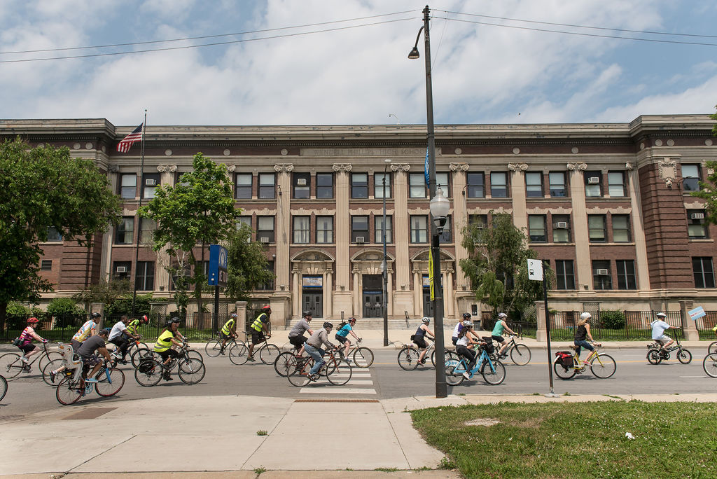 Group of bicyclists in front of a building