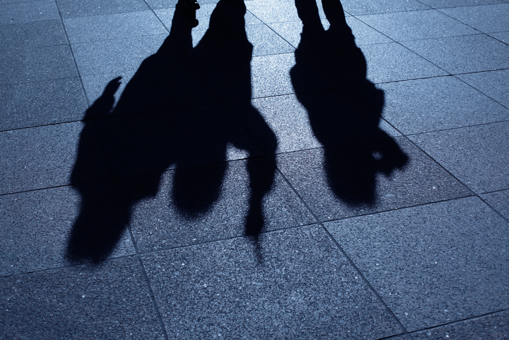 Shadowy figures on pavement