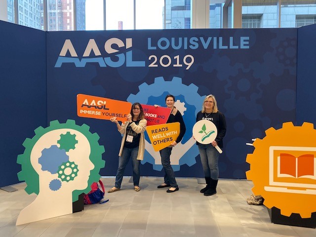 Three women standing in front of AASL Conference sign 