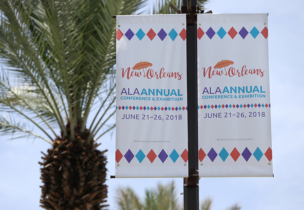 A street banner that reads "New Orleans - ALA Annual Conference, June 21-26-2018"