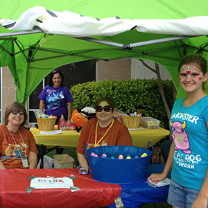 Beauregard Parish Library staff and a preteen patron prepare for the 2013 SRP Kickoff Carnival.