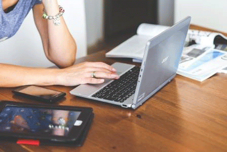 Closeup of women using laptop