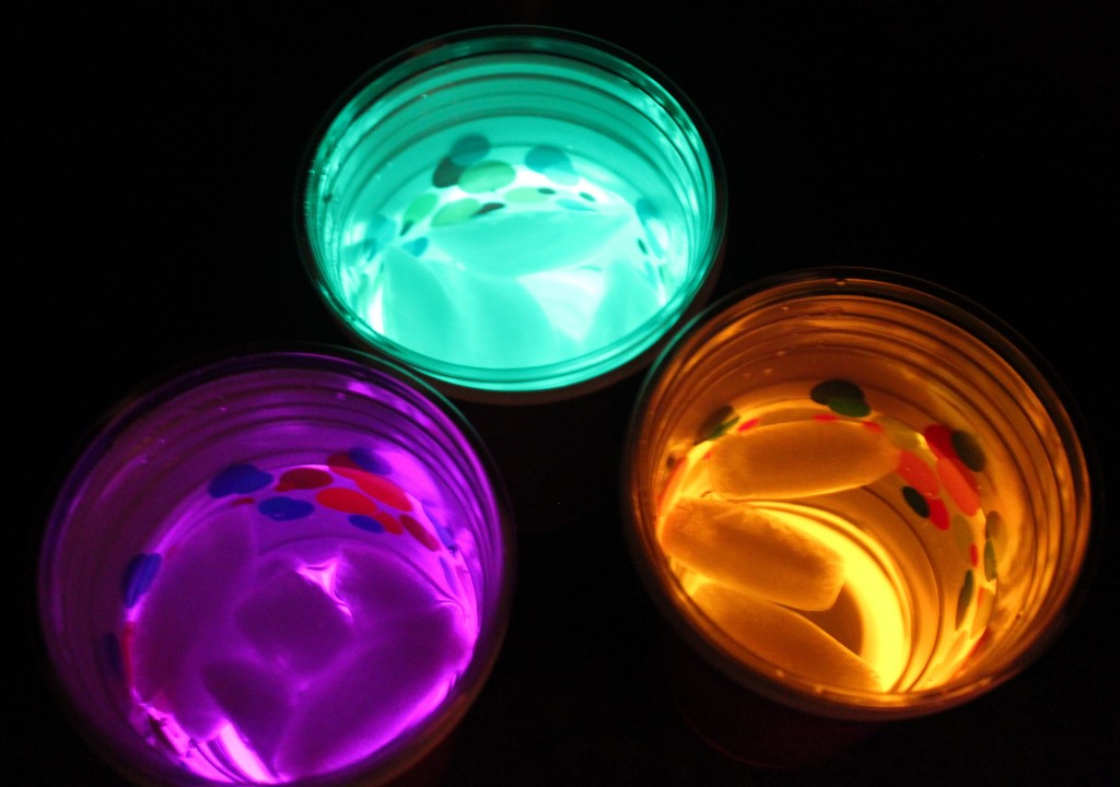 Serve party beverages from neon cups, made from glow sticks and plastic cups.