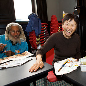 A woman enjoys a painting class at a Creative Aging program.  (Lifetime Arts, Inc.)