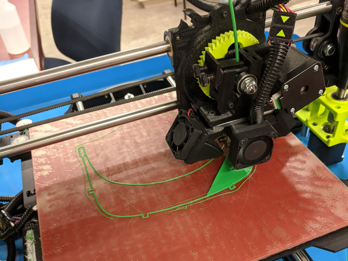 A 3D printer making face shields for PPEs.