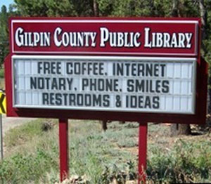 Sign for the Gilpin Public Library: "Free coffee, internet, notary, phone, smiles, restrooms & ideas"