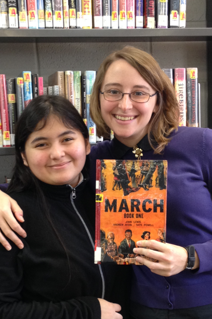A librarian and a student hold a copy of "March: Book One"