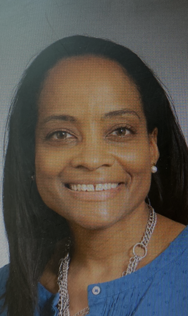 Headshot of Marlowe Bogino, a Black woman with long black hair