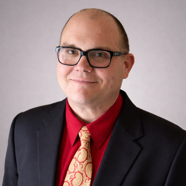 Headshot of Dr. Witt Salley, a white man with very short brown hair and thick framed black glasses