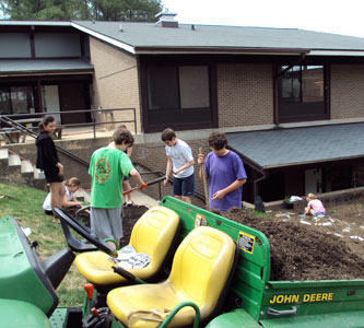 Students work on creating an organic vegetable garden outside the library.