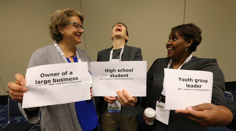 Librarians laugh during a dialogue and deliberation workshop