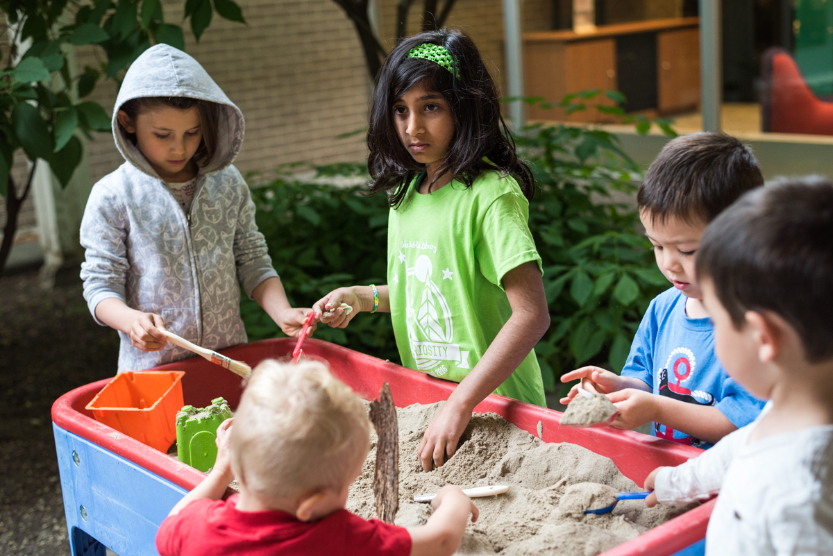 Kids playing with a sand table.