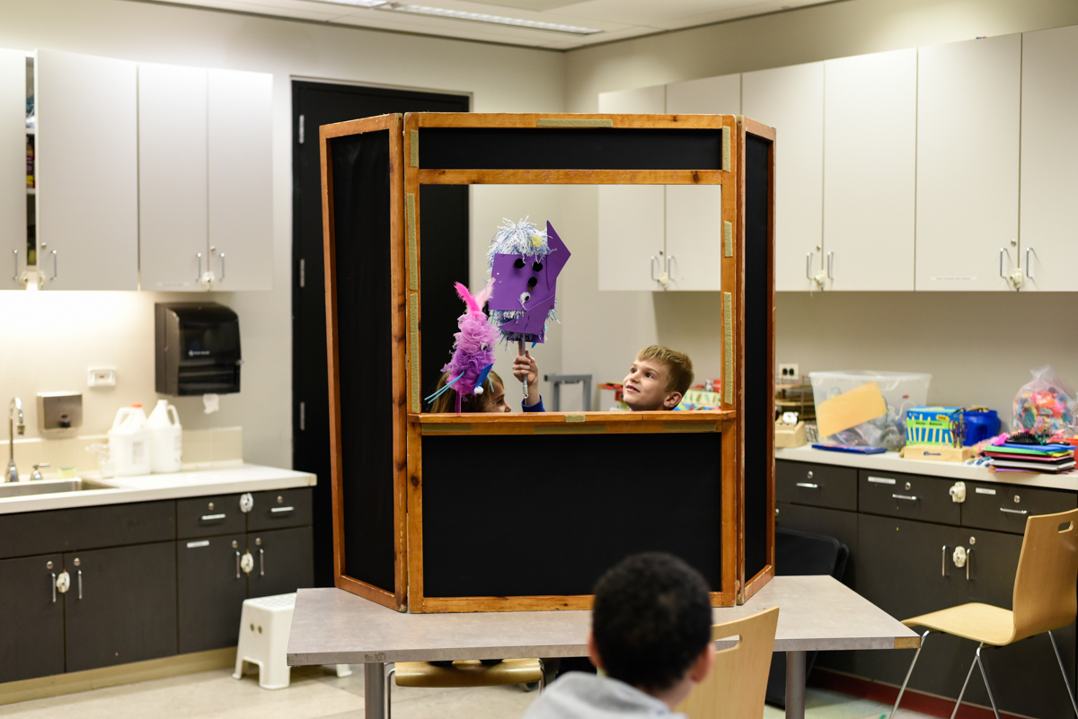 Kids putting on a puppet show