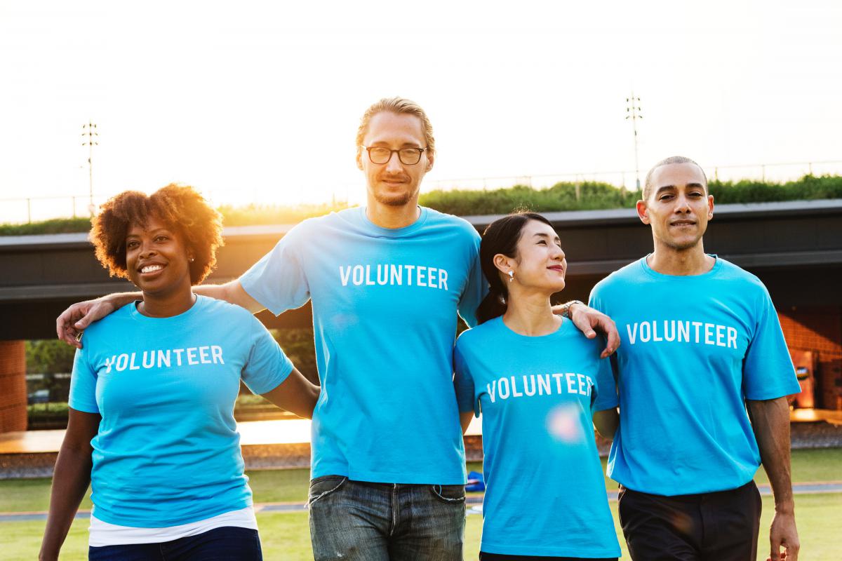 A group of people wearing "volunteer" t-shirts