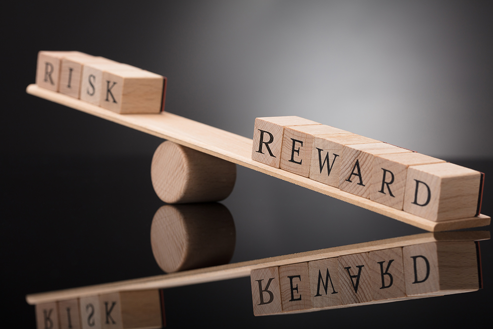 Word tiles that read "risk" and "reward"
