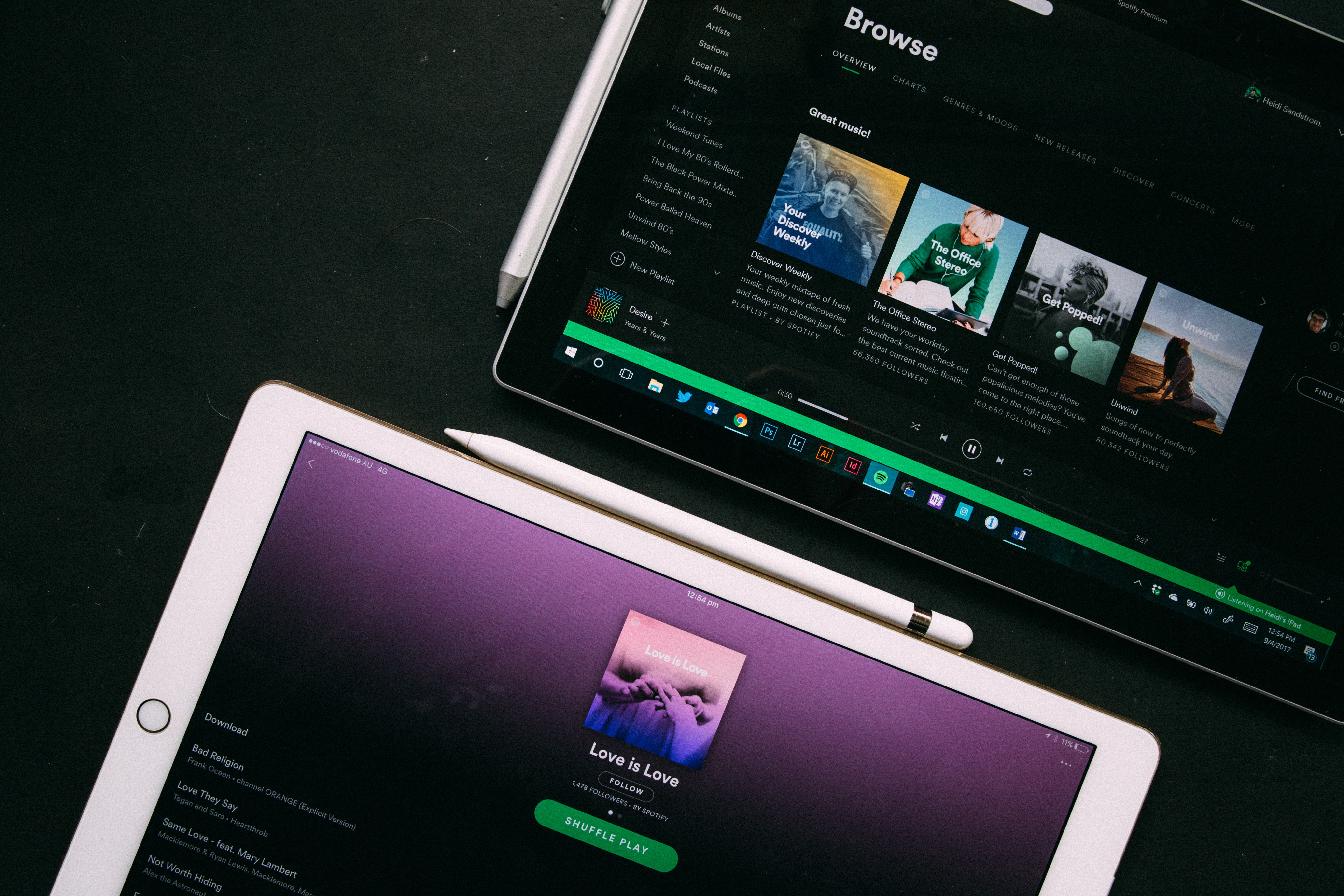Photograph of two iPads open on the Spotify app.