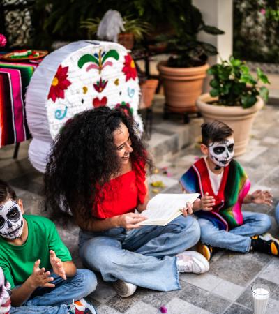 Latino women and children enjoy a Day of the Dead celebration