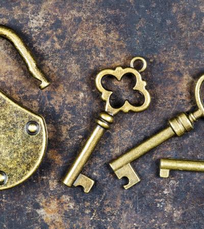 vintage keys and padlock on a rusty metal background