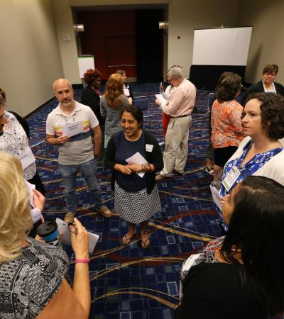 Librarians standing in a circle at a workshop at the ALA Annual Conference. 