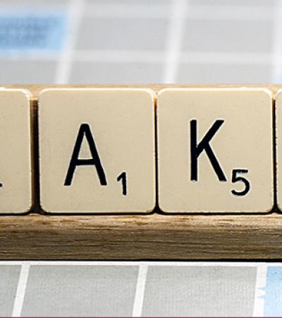 Scrabble tiles that spell out "fake"
