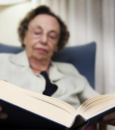 older woman reading a book