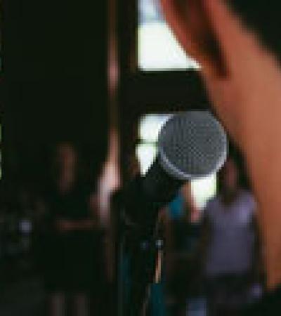 Man standing behind a microphone