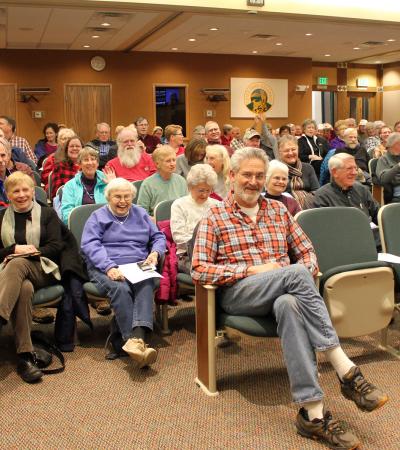 Patrons wait for the lecture to begin.