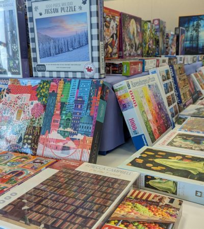 Photograph of tables set up with boxes of puzzles