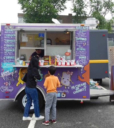 Trucks! Trucks! Trucks! Mother and son ordering at a food truck