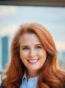 person with red hair smiling
