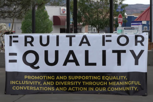 Banner draped over an outdoor table. Text on the banner reads: Fruita For Equality