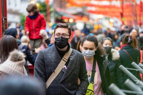 people wearing masks in a crowd