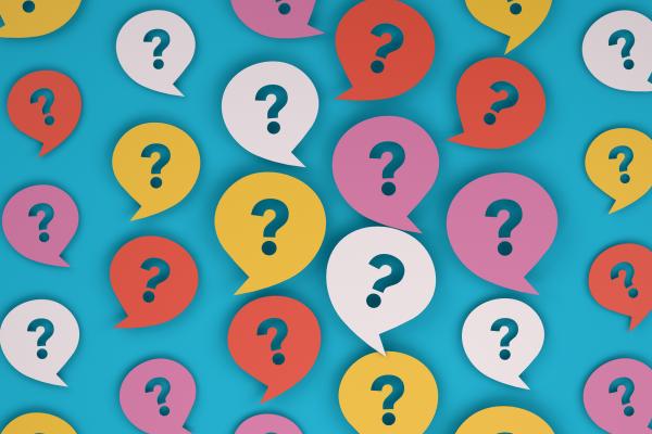 Image shows colorful question marks on speech bubbles against a blue background.