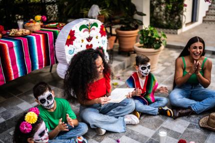 Latino women and children enjoy a Day of the Dead celebration