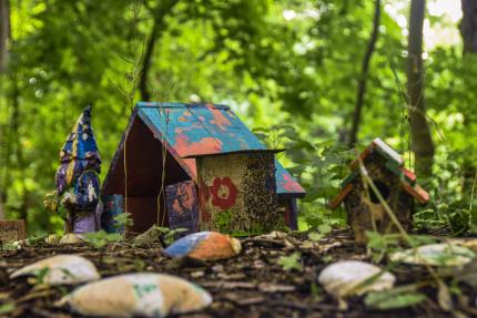 miniature painted "gnome house" in the woods