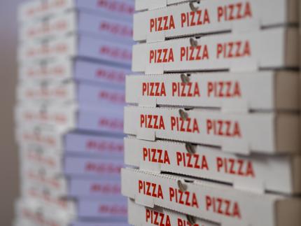 pizza boxes slant-angle view of stacks of pizza boxes